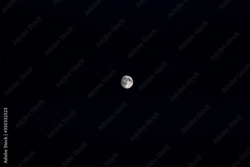 Almost full moon in the center of the black night sky. Astronomy. Almost full moon in the center of the black night sky. Astronomy.