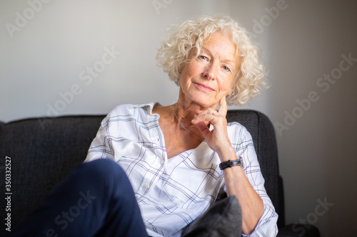older woman relaxing on sofa at home