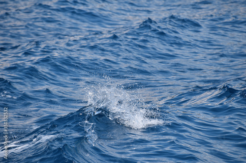 Blue sea water surface with ripples and waves