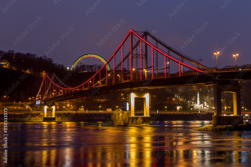 Night view of the Dnieper river, pedestrian bridge