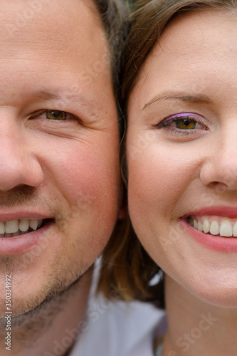Face of man and woman close-up. The couple is looking into the frame. Gender of a woman   s face and gender of a man   s face. Comparison of man and woman. Both are smiling.
