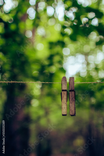 Two clothespins on a rope close-up in the forest