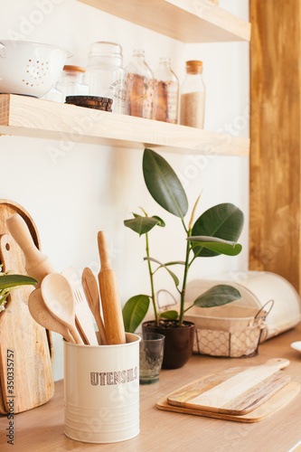 wooden rustic kitchen table. minimalistic interior, utencils on the table