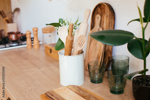 wooden rustic kitchen table. minimalistic interior, utencils on the table