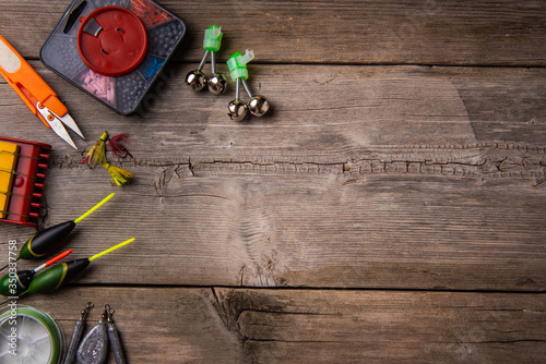 Background from fishing gear laid out on an old wooden table. flat lay. Fishing background. View from above