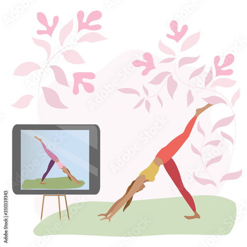 Young woman doing yoga at home. Yoga online.