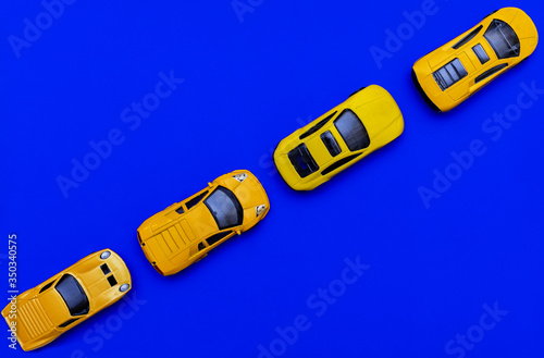 Yellow cars on a blue background. Transport. Traffic jam, keep your distance. Flat lay, copy space, top view.