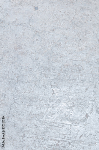 Light white aged concrete polished in cracks.