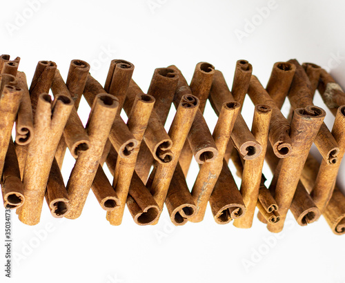 Cinnamon sticks are figuratively lying on a white background photo