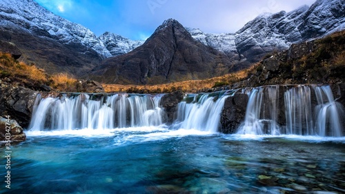 Fairy Pools waterfall on the dramatic Isle Of Skye in scenic Scotland, a fantastic adventure travel destination for a holiday vacation to view awesome picturesque scenery