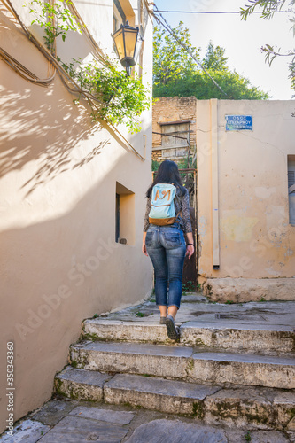 A young tourist woman wandering through the side streets of Plaka in Athens Greece © Andreas Lorentzatos