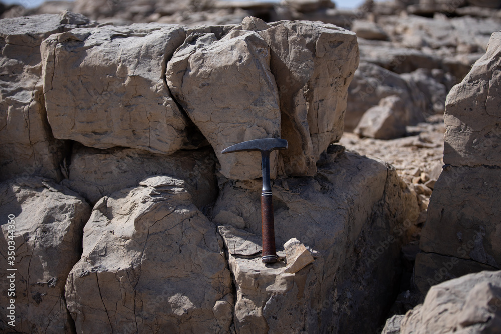 Limestones and testing hammer of geologists in limestone quarries Limestones and testing hammer of geologists in limestone quarries