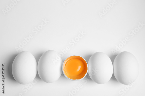 Fresh raw chicken eggs on white background, flat lay. Space for text