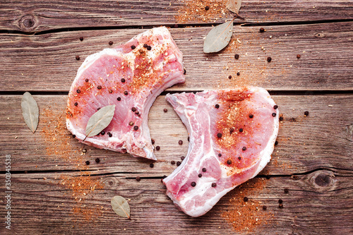 T-bone meat for cooking on a wooden background