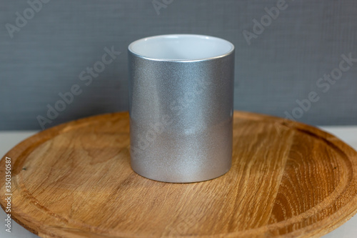 silver sublimation cup on a wooden stand