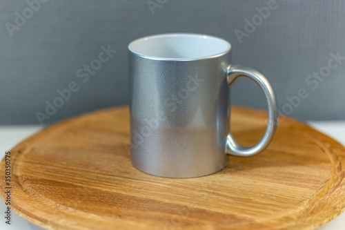 silver sublimation cup on a wooden stand