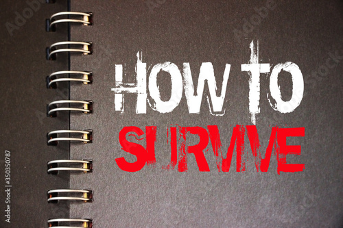 How to survive words on page of copybook. Surcvival concept. Crisis management business concept. Coronavirus prevention concept