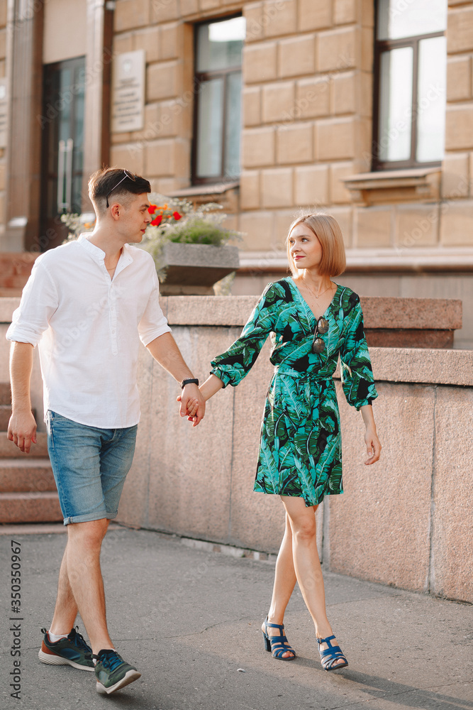 Young couple in love is hugging. In the city, a summer love story. Full height photo Young couple in love is hugging. In the city, a summer love story. Full height photo
