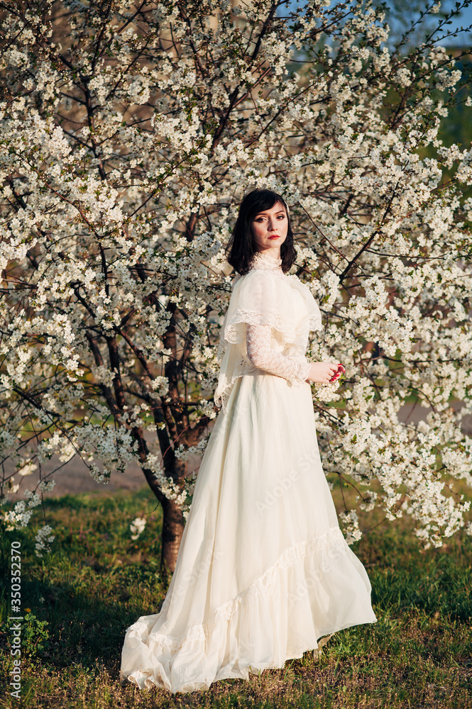 Fototapeta premium girl next to a flowering tree