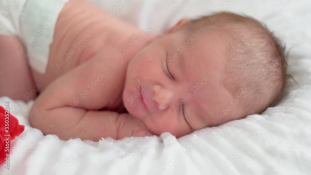 Cute little newborn baby girl sleeping and yawning in a dream Cute little newborn baby girl sleeping and yawning in a dream