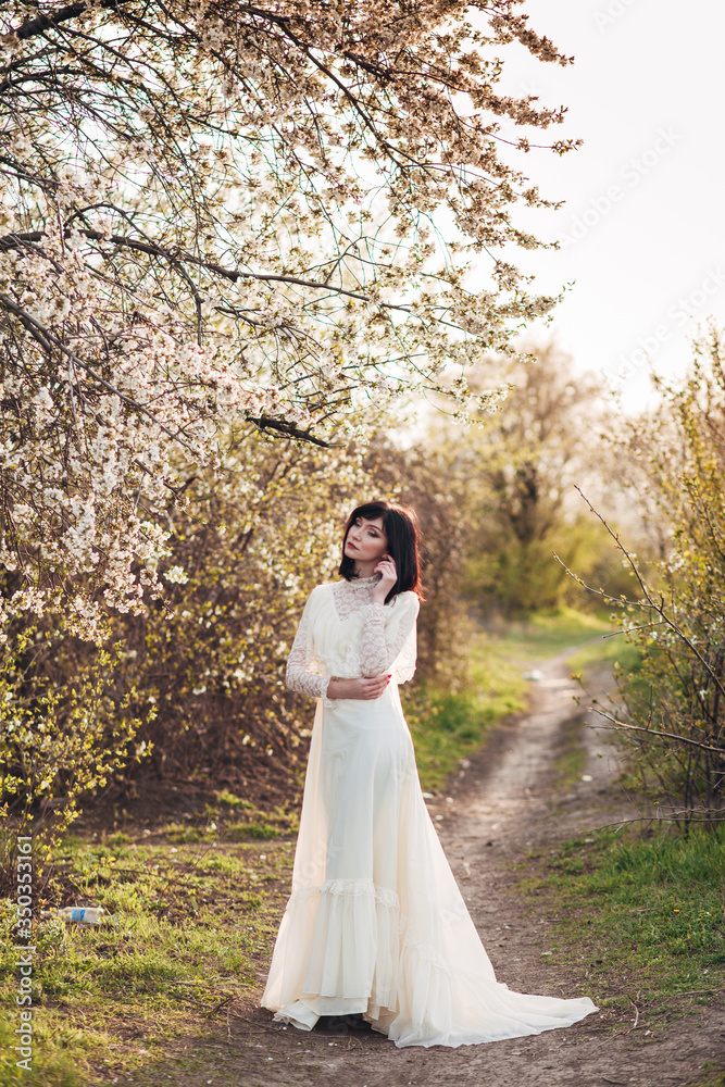 woman in white flowering trees