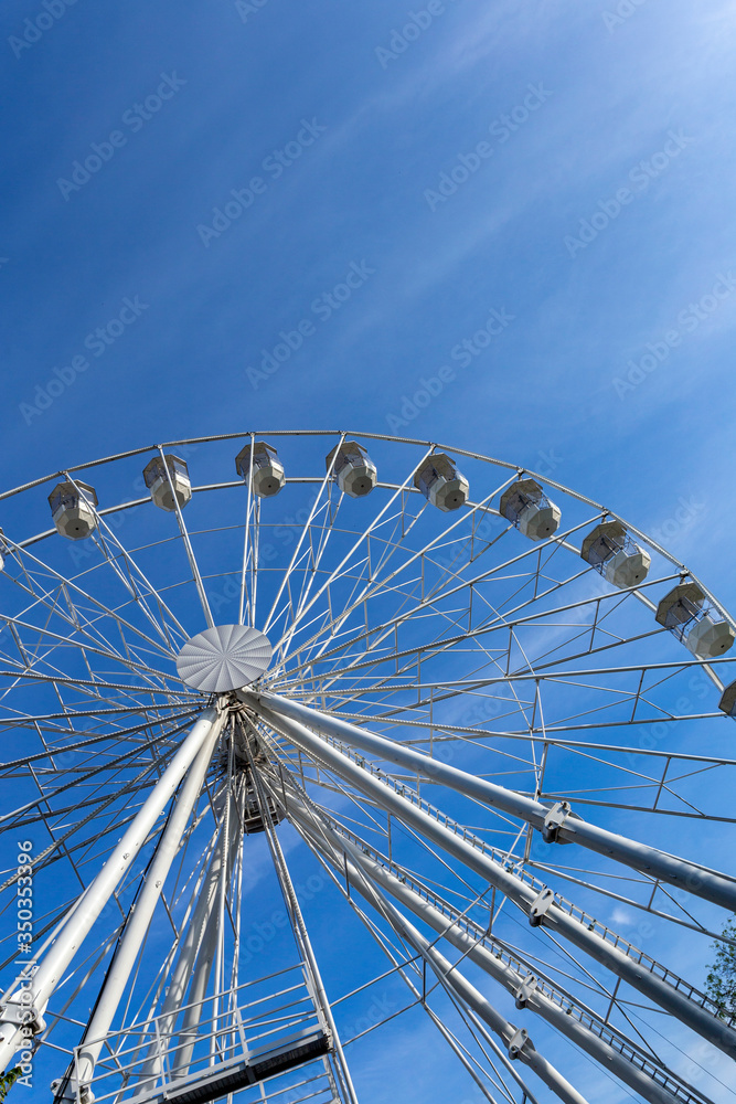 Empty ferris wheel with a blue sky in the background