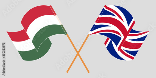 Crossed and waving flags of Hungary and the UK