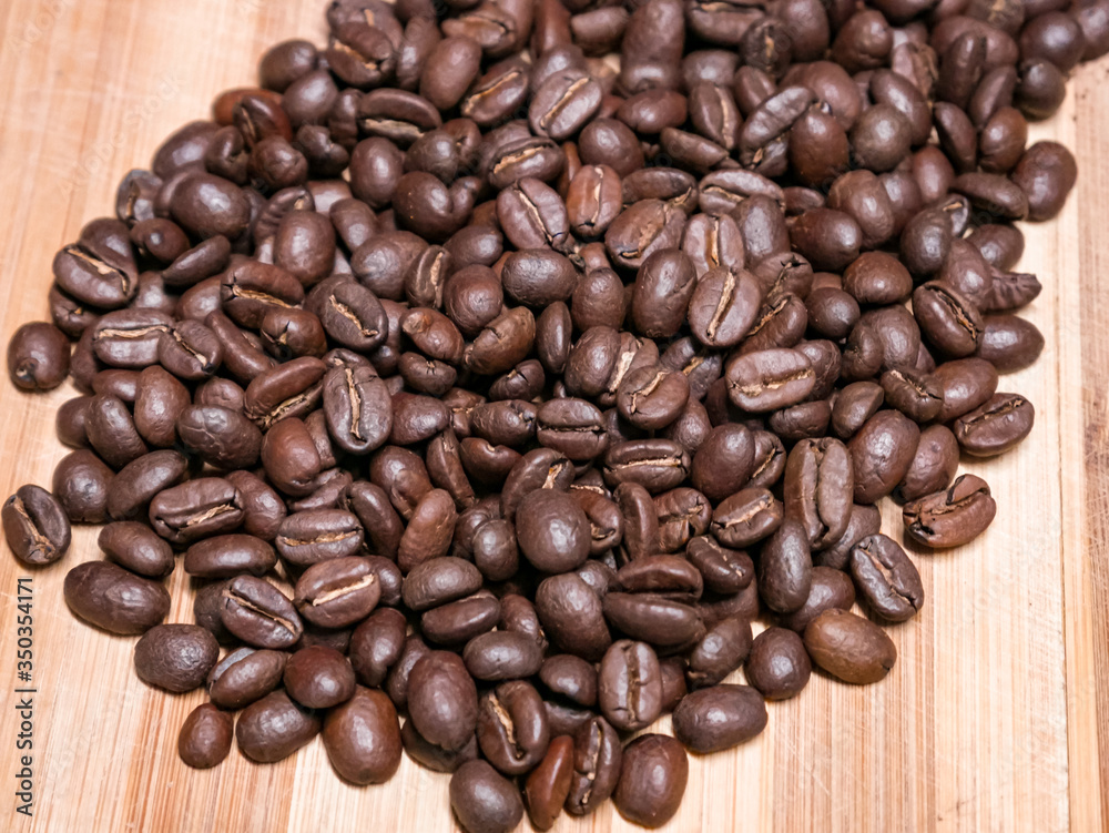 Fototapeta premium Large coffee beans on wooden board