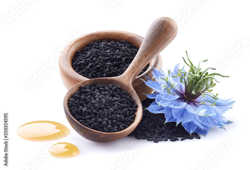 Black cumin seeds with oil drop and flower