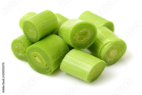 Фотография young green garlic leaves isolated on white background