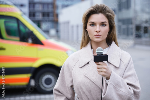 Worried news reporter speaking into a microphone