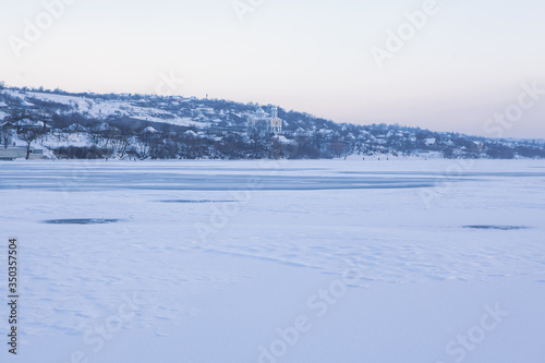 winter scenery with village and frozen lake
