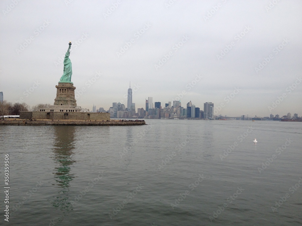 A skyline photo of the Statue of Liberty Island, New York .A nice view of Manhattan in the far back