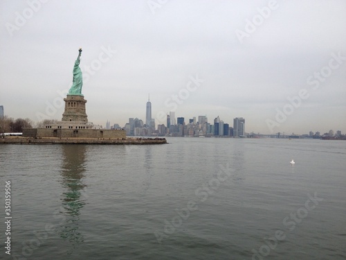 A skyline photo of the Statue of Liberty Island  New York .A nice view of Manhattan in the far back
