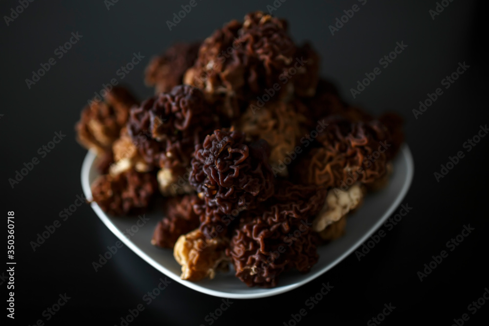 mushrooms on a plate on a black background mushrooms on a plate on a black background