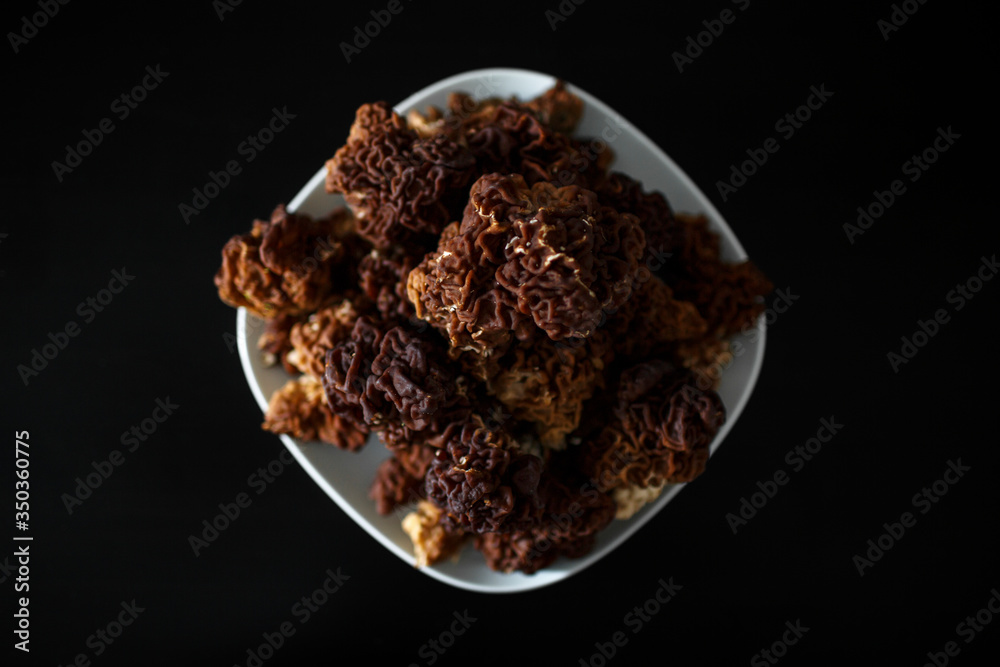 mushrooms on a plate on a black background mushrooms on a plate on a black background