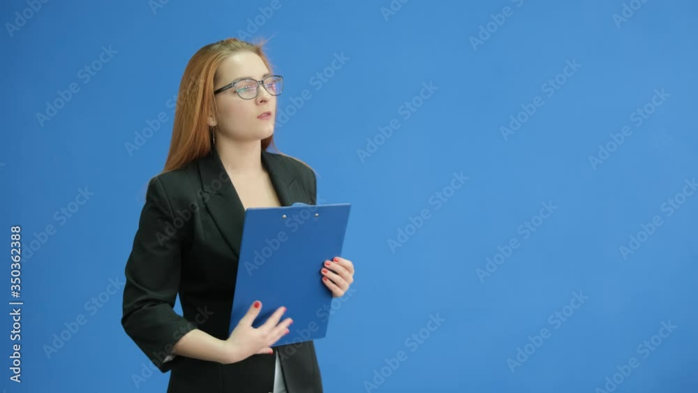Office young woman with a document holder in the hand are looks seriously Office young woman with a document holder in the hand are looks seriously