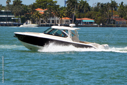  black and white cabin cruiser powered by two outboard engines. © Wimbledon