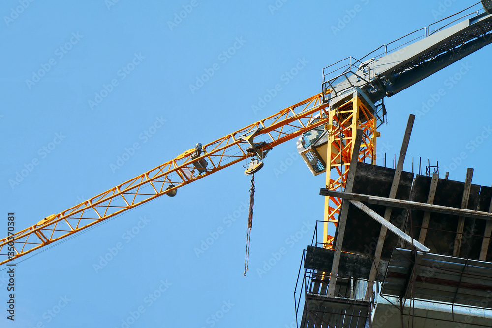 Construction crane near the building under construction