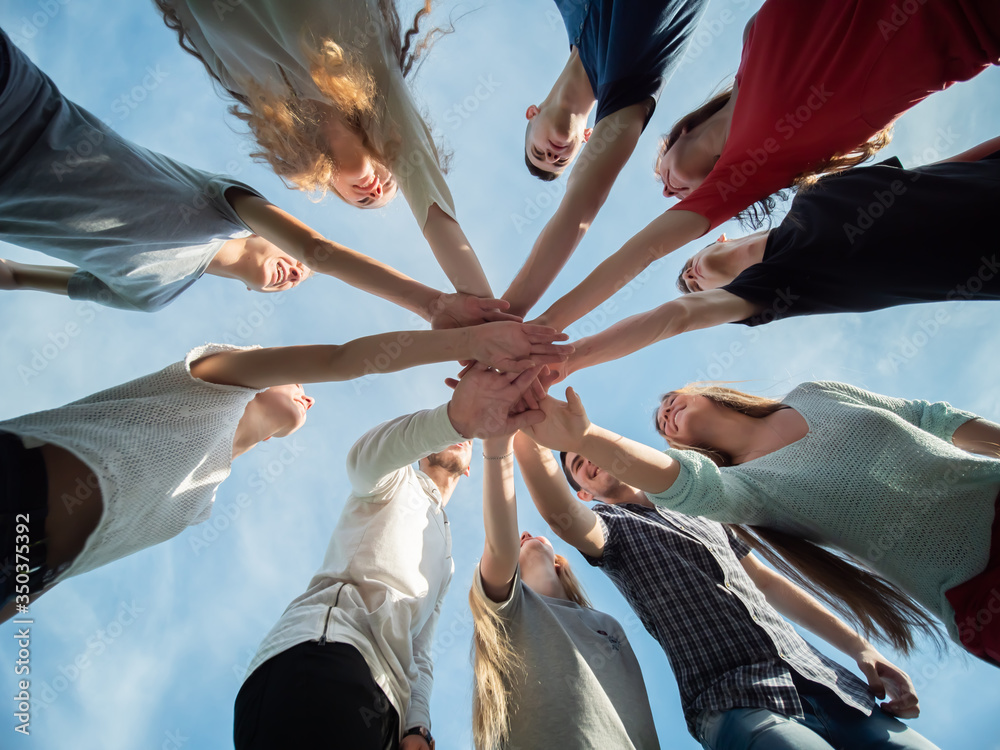 © Довидович Михаил - A friendly company of friends join hands as a sign of joint business. © Довидович Михаил - A friendly company of friends join hands as a sign of joint business.