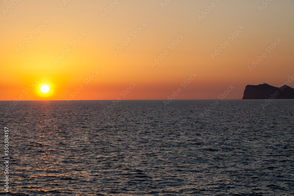Sunset in the Mediterranean sea. Sun sky and clouds at sunset over the island of Majorca.