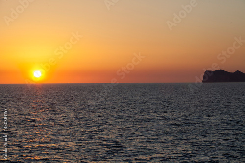 Sunset in the Mediterranean sea. Sun sky and clouds at sunset over the island of Majorca.