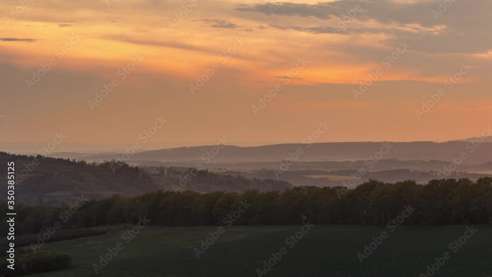 Timelapse of orange moving clouds over forests and hills of Beskydy Czech Republic national park area over nature with moving clouds during sunset. Timelapse of orange moving clouds over forests and hills of Beskydy Czech Republic national park area over nature with moving clouds during sunset.