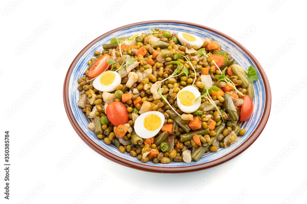 Mung bean porridge with quail eggs, tomatoes and microgreen sprouts isolated on a white background. Side view. Mung bean porridge with quail eggs, tomatoes and microgreen sprouts isolated on a white background. Side view.