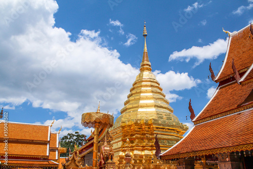 Wat Phra That Doi Suthep with clouds on blue sky in the afternoon, the most famous temple in Chiang Mai, Thailand