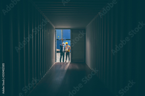 engineer foreman worker opening the doors of a cargo container, view inside the cargo, concept of international logistic industrial with import and export product © chokniti