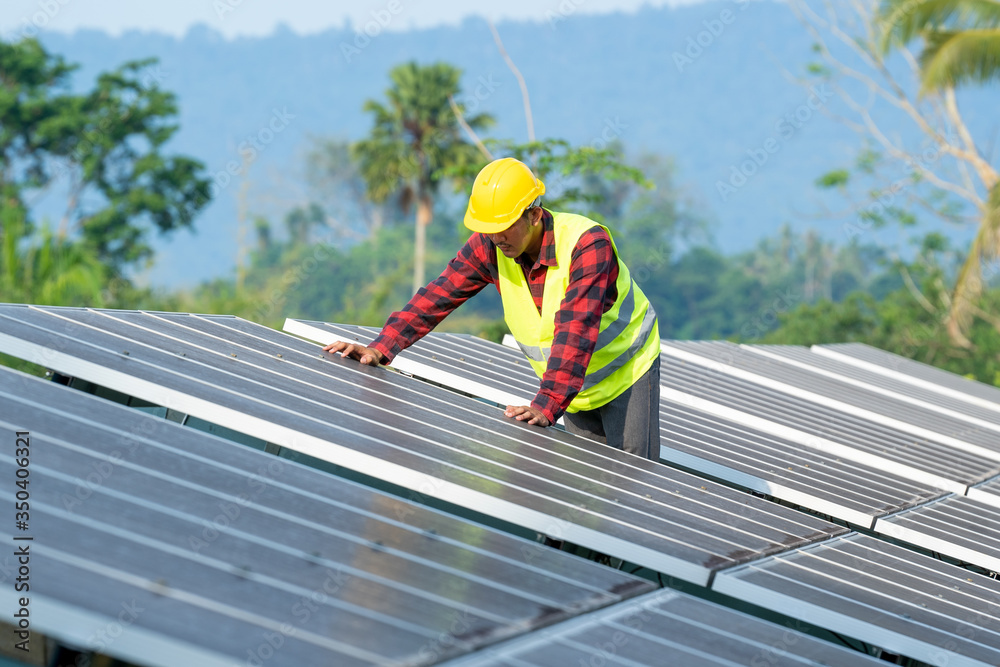 Solar power plant,Engineer working on checking and maintenance in solar power plant on a background of photovoltaic panels,Science solar energy.