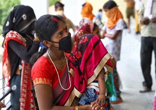 15 may 2020,sirsa\haryana\india
a migrant worker watering his child during regestration and thermal scanning  afterthat they will allowed to travel back to their homes during nationwide lockdown photo