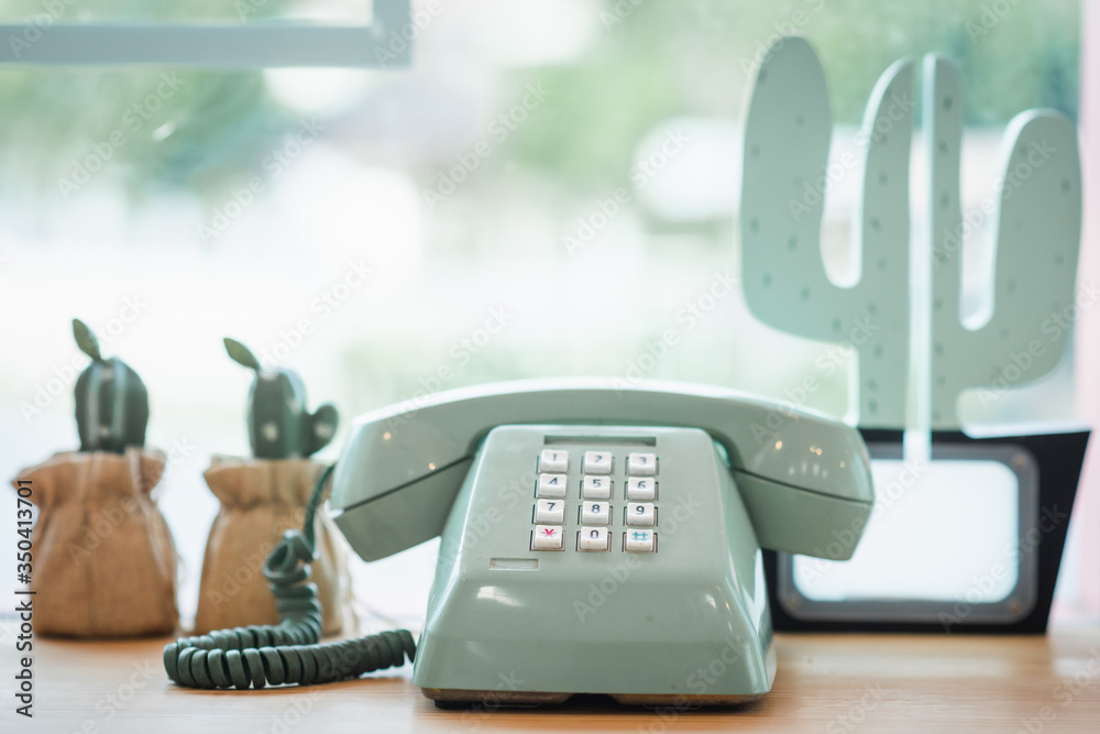 Retro green rotary telephone on wood table Retro green rotary telephone on wood table