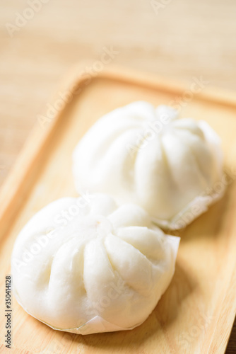 Steamed buns stuffed with minced pork on plate, Asian food